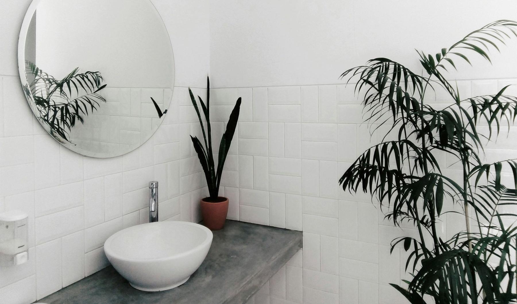 a bathroom with a round mirror